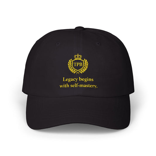 Black male model in premium black dad cap featuring gold TPB crest and “Legacy begins with self-mastery” motivational message